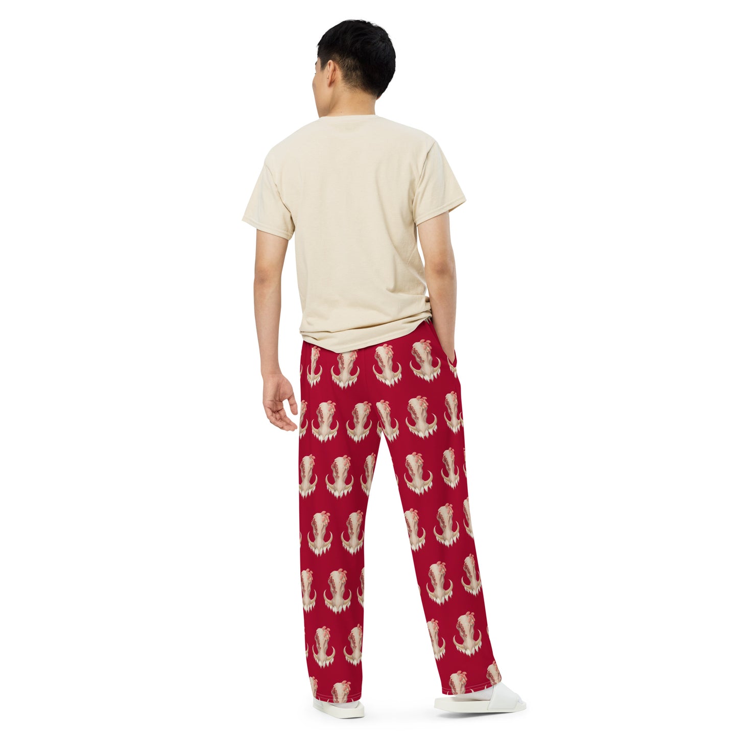 Unisex, medium dark red pants with elastic band and relaxed fit featuring an all over print design with a front facing warthog skull with 3 different kinds of fungi growing out of it