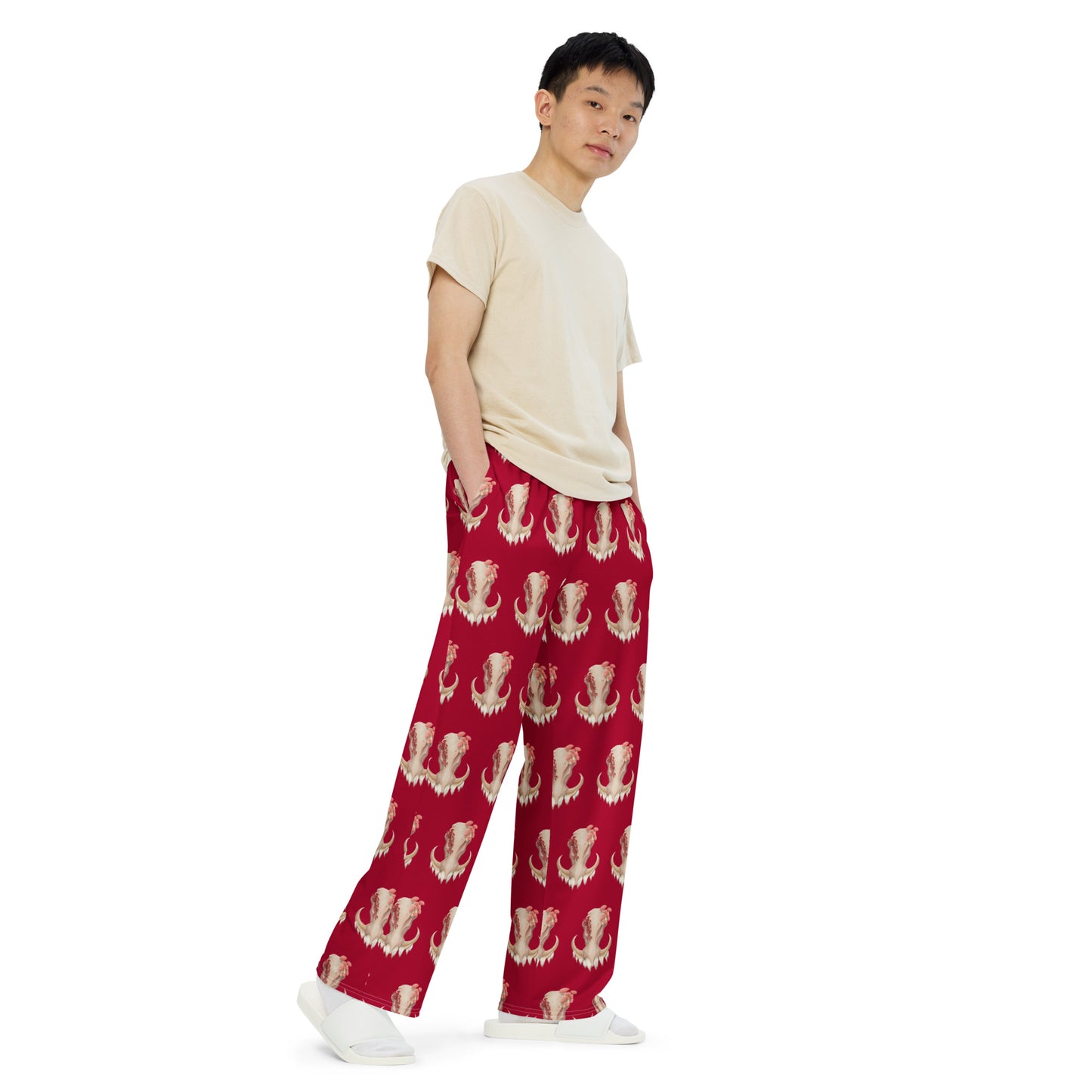 Unisex, medium dark red pants with elastic band and relaxed fit featuring an all over print design with a front facing warthog skull with 3 different kinds of fungi growing out of it