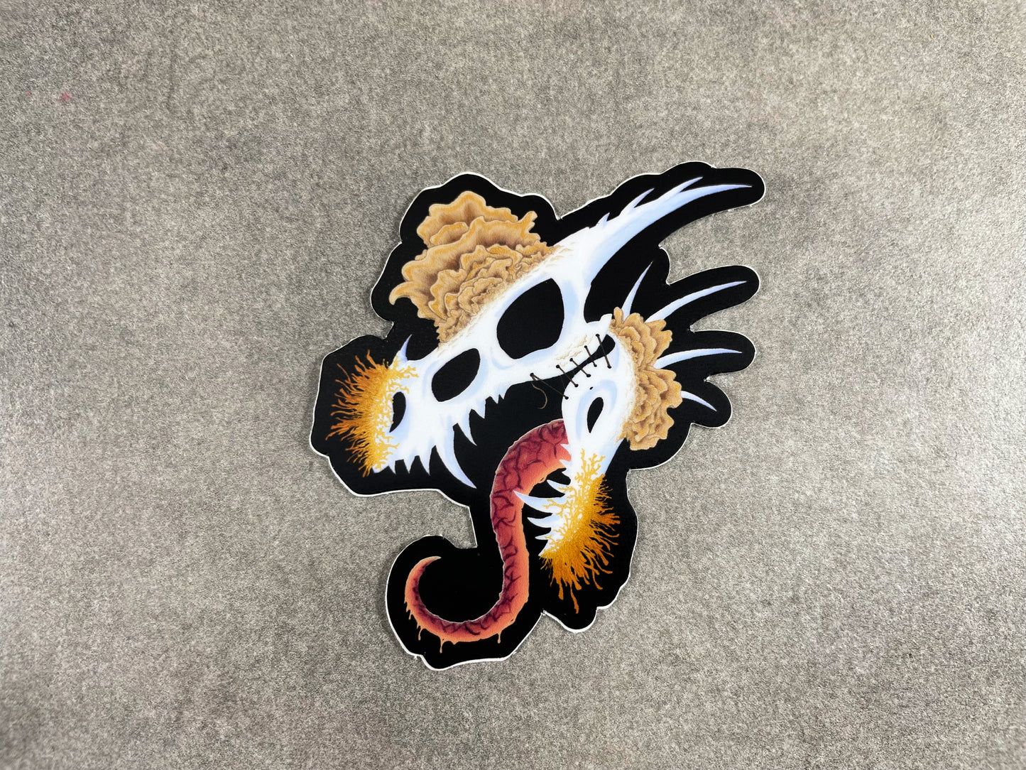 dragon skull with three different types of mushrooms growing from it on a matte die cut sticker