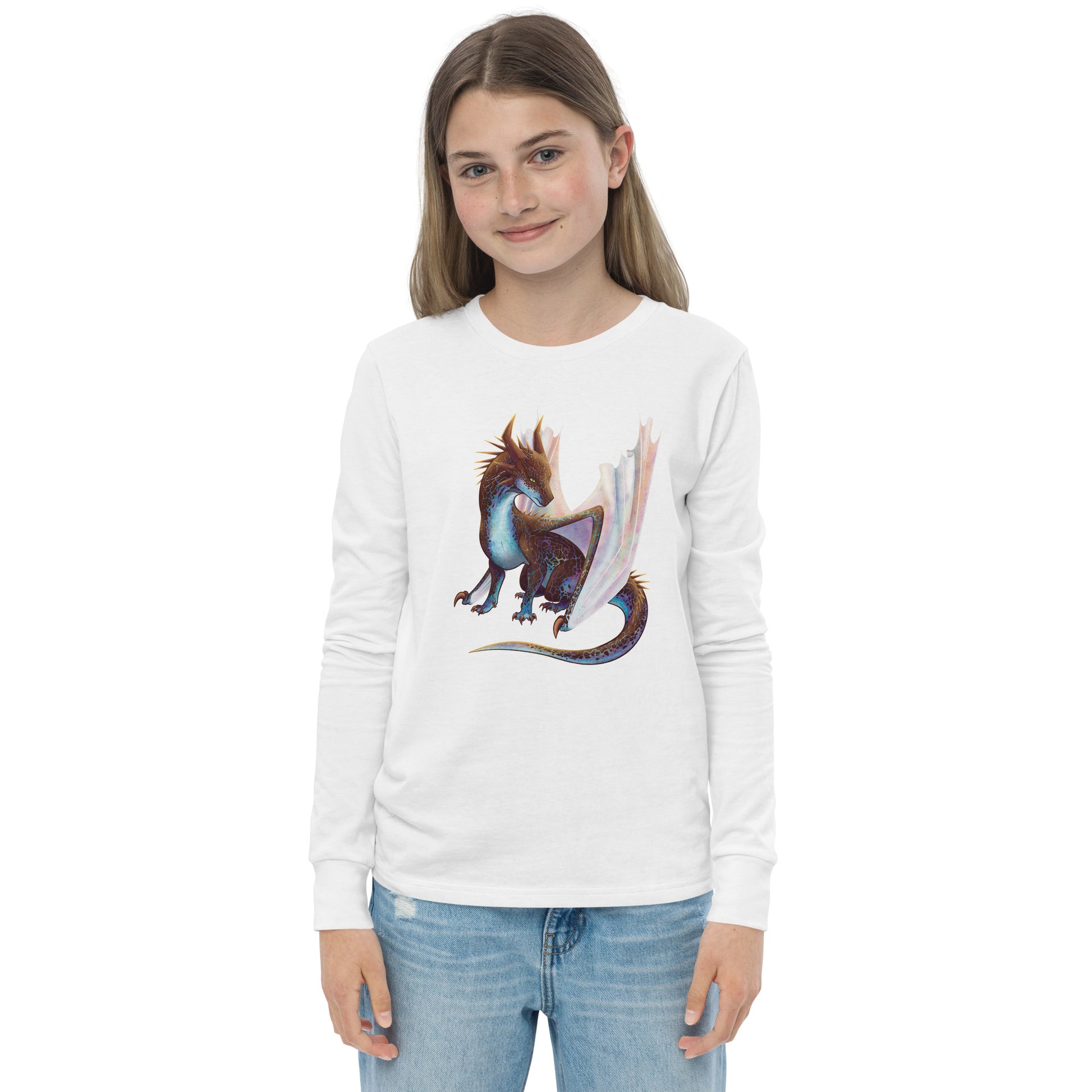 Unisex, white in color, youth long sleeve shirt featuring a sitting, side profile of a dragon that has the features of a boulder opal with hues of blue, green, purple, and pink on the underbelly and cracks of the rough, brown hue, rock scales. The wings are tucked back and are of an iridescent shimmery hue